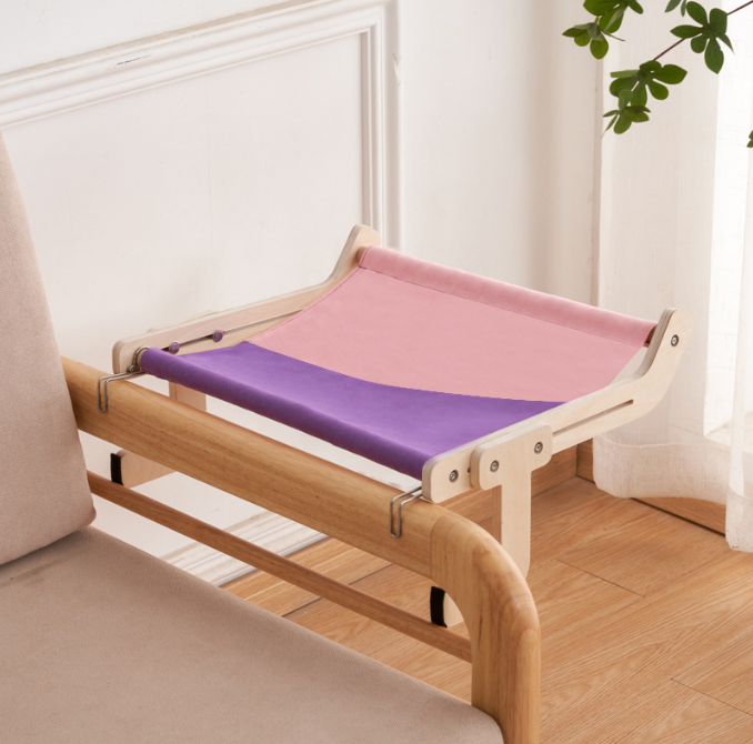 No-Suction Wooden Cat Window Perch - Heavy-Duty Adjustable Hook-On Shelf & Safety Sun Lounger featuring a sturdy wooden frame with pink and purple fabric, attached to a chair armrest.