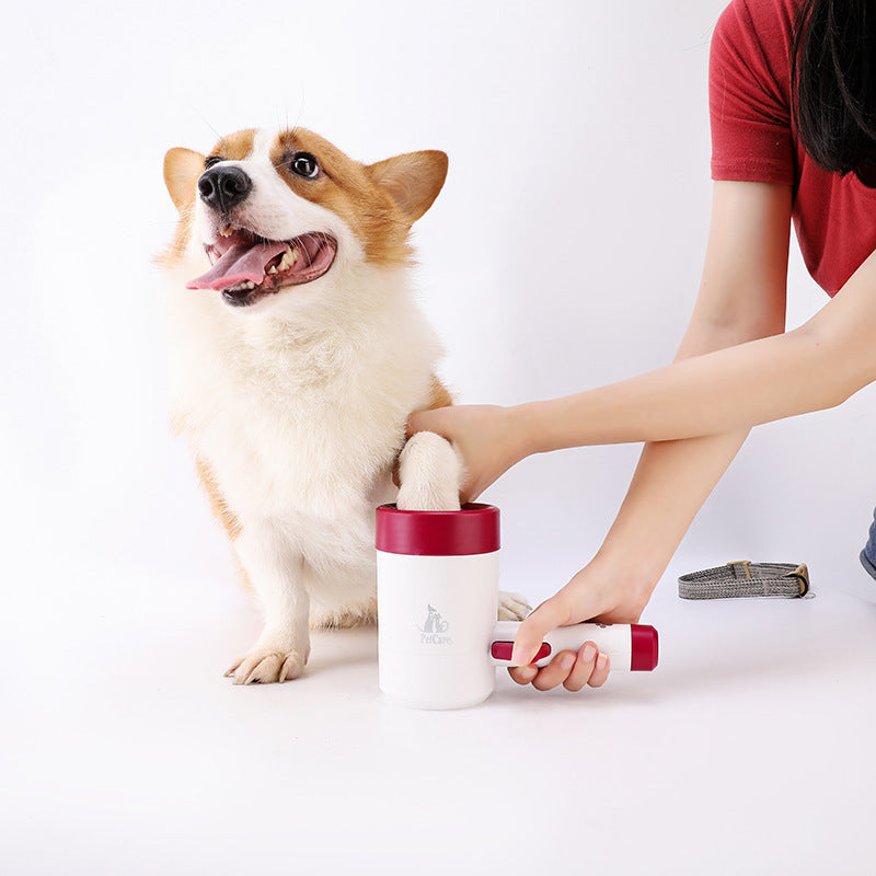 Woman using the Automatic Electric Dog Paw Cleaner - 360° Rotating Scrub-Free Washer on a happy corgi with a white background, demonstrating gentle paw cleaning.