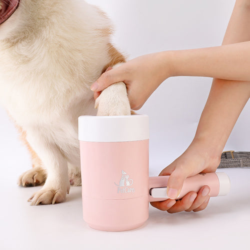 A person using the Automatic Electric Dog Paw Cleaner - 360° Rotating Scrub-Free Washer in pink to clean a dog's paw, demonstrating easy and gentle pet hygiene.