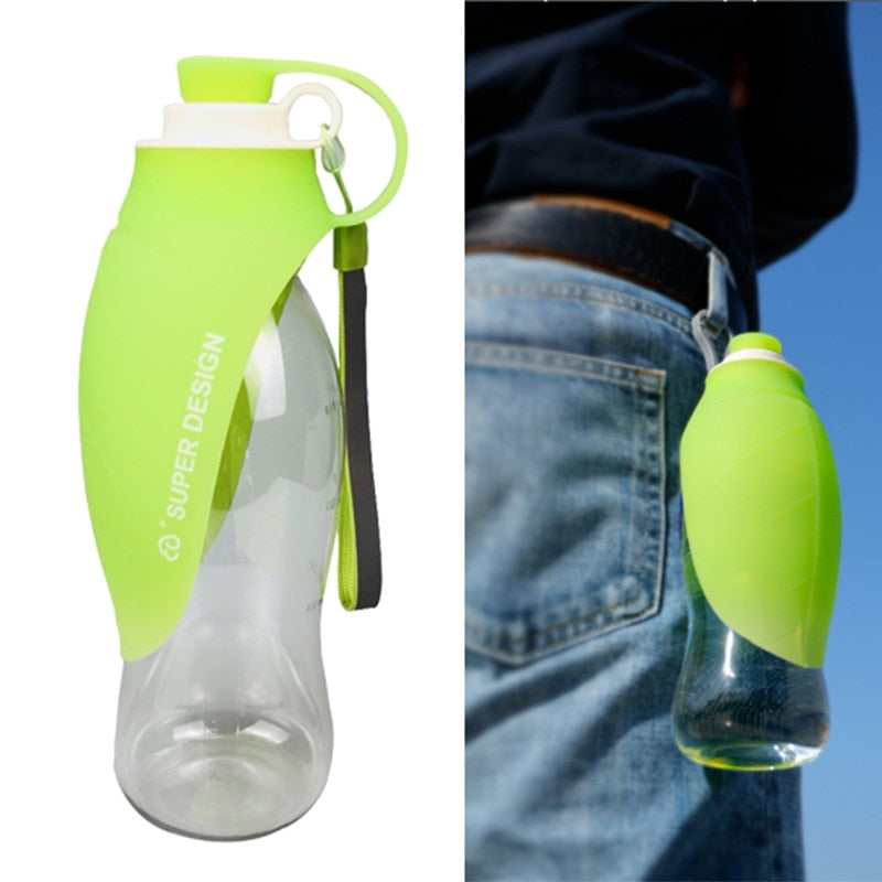 Large Silicone Leaf Bottle - 580ml Portable Travel Bottle in green with a leaf-shaped silicone cover and wrist strap, shown hanging from a belt loop for hands-free carrying.