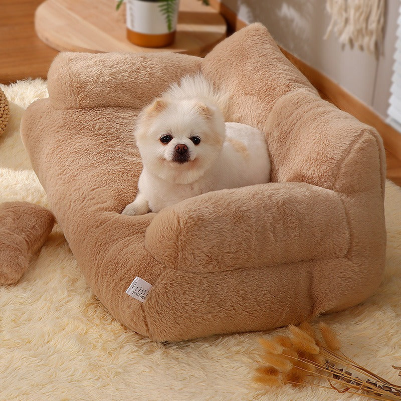 Small white dog resting comfortably on a beige Orthopedic Calming Pet Sofa - Luxury Plush Dog & Cat Bed Couch with Bolster Support in a cozy indoor setting.