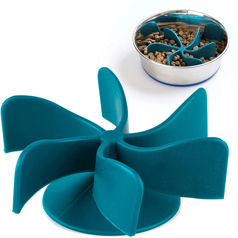 Blue spiral insert designed to slow pet eating placed next to a stainless steel bowl filled with dry kibble, featuring the Universal Propeller Slow Feeder Insert - Spiral Anti-Gulping Solution.