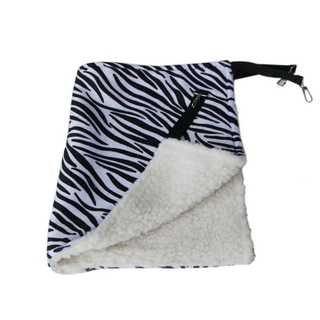 Thermal Hanging Cat Hammock - Double-Sided Winter Warm Fleece Bed for Cages, Crates & Chairs with zebra print exterior and soft white plush fleece interior, featuring adjustable straps and clips.