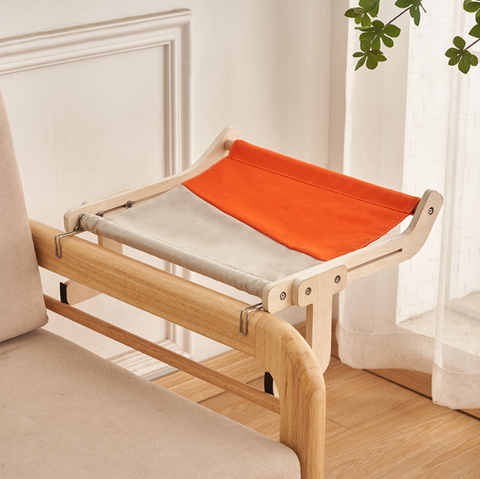 No-Suction Wooden Cat Window Perch - Heavy-Duty Adjustable Hook-On Shelf & Safety Sun Lounger attached to a wooden chair, featuring a sturdy wood frame with orange and beige fabric for pet comfort.