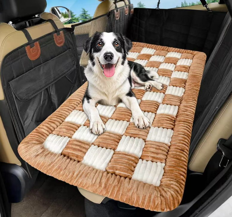 A happy black and white dog lying on the Designer Checkered Travel Dog Bed - Thickened Quilted Car Seat Mat - Nonslip Portable Pet Sleeping Pad placed on the back seat of a car.
