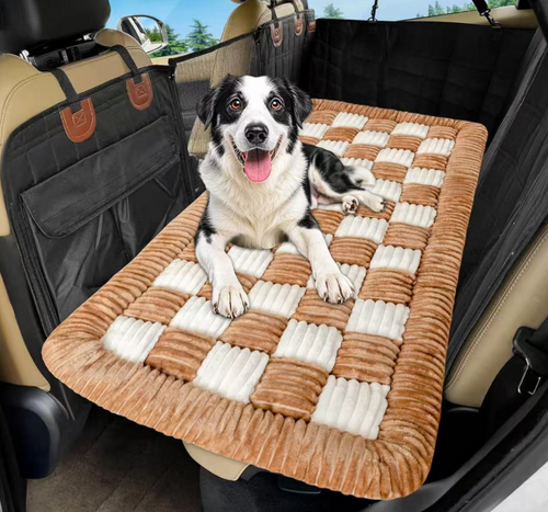 A happy black and white dog lying on the Designer Checkered Travel Dog Bed - Thickened Quilted Car Seat Mat - Nonslip Portable Pet Sleeping Pad placed on the back seat of a car.