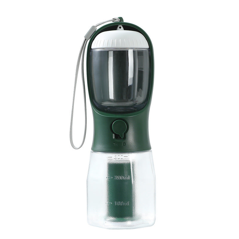 3-in-1 Pet Travel Station – Integrated Water, Food & Waste Management bottle in dark green and clear with measuring marks and a wrist strap for easy carrying during outdoor activities.
