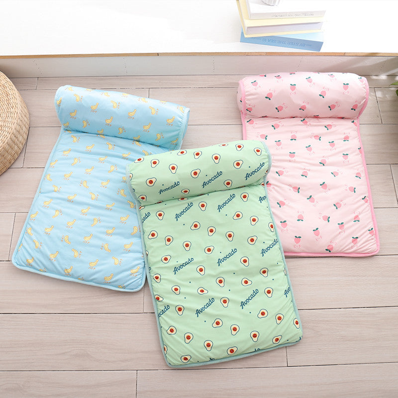 Three Boutique Ice-Silk Cooling Mat - Patterned Heatstroke Prevention Sleeping Beds in pastel blue with duck print, light green with avocado print, and pink with strawberry print arranged on a light wood floor.
