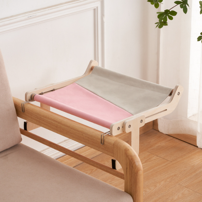 No-Suction Wooden Cat Window Perch - Heavy-Duty Adjustable Hook-On Shelf & Safety Sun Lounger attached to a wooden chair frame with a two-tone fabric surface in soft pink and gray.