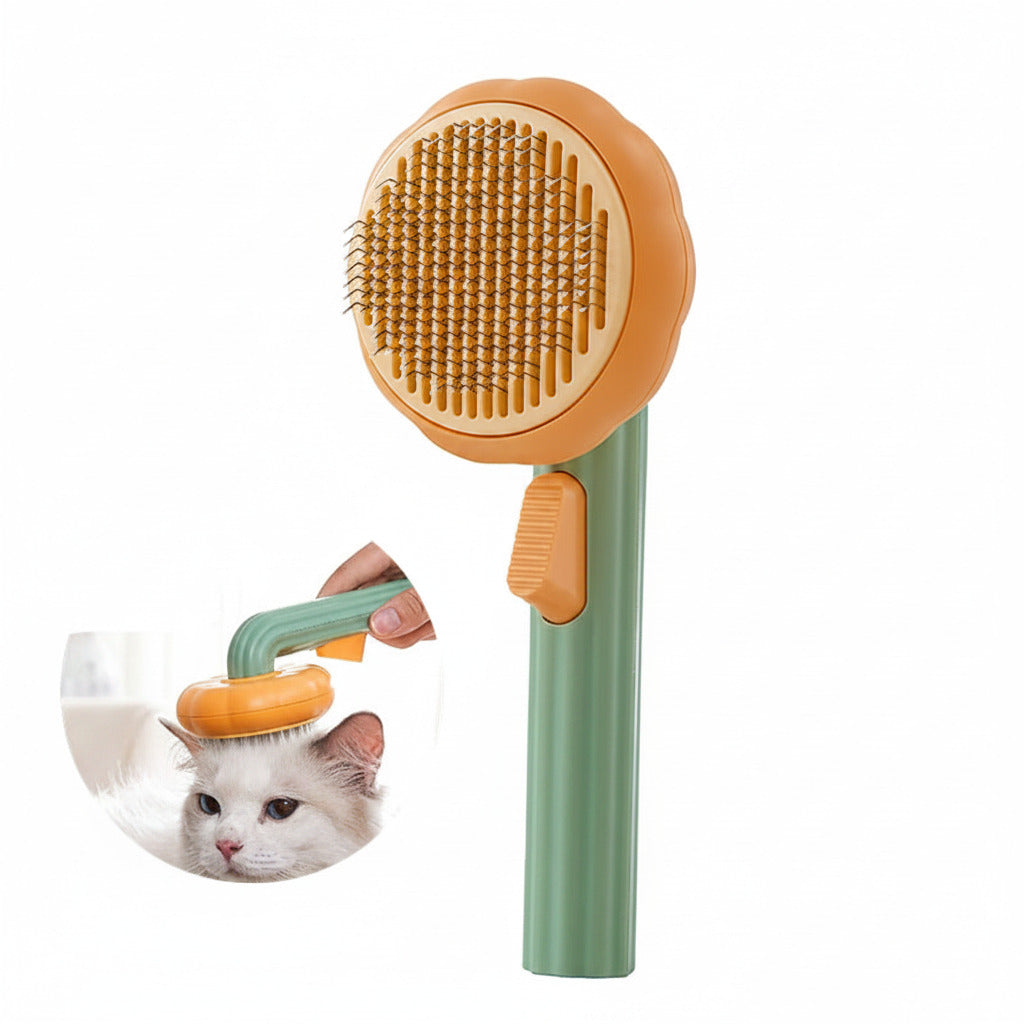 Boutique Pumpkin Self-Cleaning Brush - Aesthetic Grooming & Deshedding Comb in green and orange with ergonomic handle shown grooming a white cat, designed for easy fur removal and pet care.
