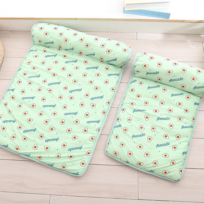 Two green Boutique Ice-Silk Cooling Mats - Patterned Heatstroke Prevention Sleeping Bed with avocado print and attached bolsters laid on a wooden floor.