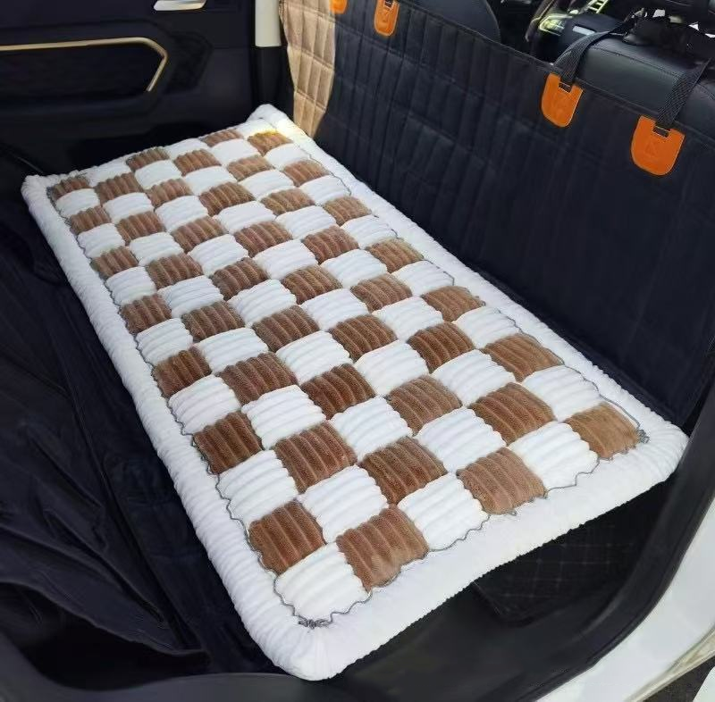 Designer Checkered Travel Dog Bed - Thickened Quilted Car Seat Mat - Nonslip Portable Pet Sleeping Pad in a checkered brown and white pattern placed on a car backseat for comfortable pet travel.