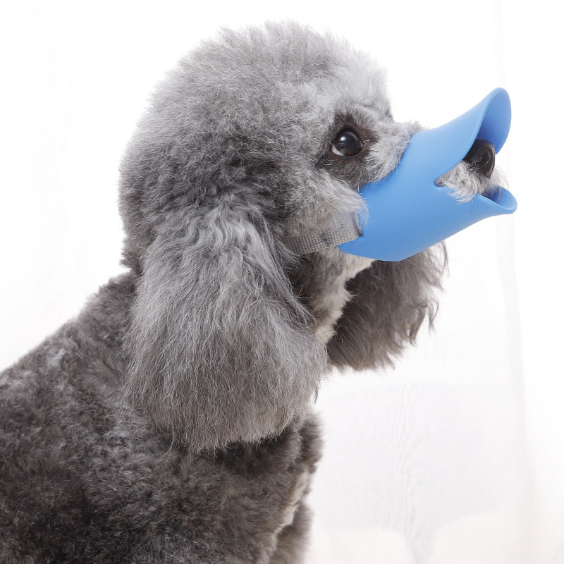 Small gray dog wearing a soft blue Soft Silicone Duckbill Muzzle - Humane Anti-Bark & Anti-Bite Training Mask that covers its snout comfortably.