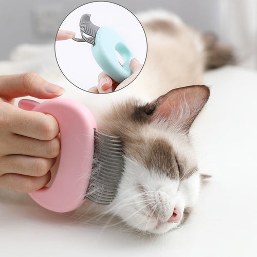 Person gently grooming a content cat with the Feline Shell Massage Comb - Whisker-Friendly Soft-Needle Deshedding Tool featuring soft needles and an ergonomic shell design.