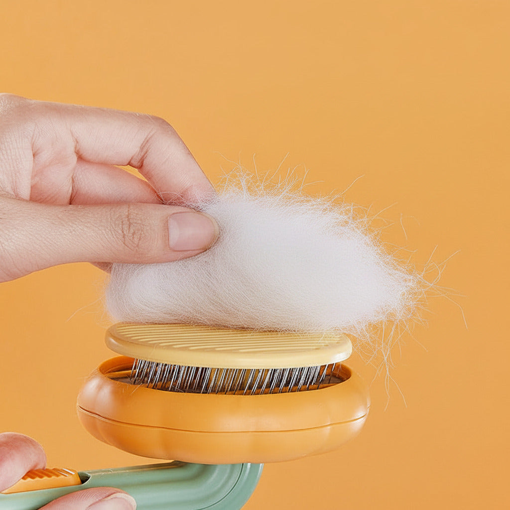 Hand holding a tuft of white pet fur collected from the bristles of the Boutique Pumpkin Self-Cleaning Brush - Aesthetic Grooming & Deshedding Comb against an orange background.