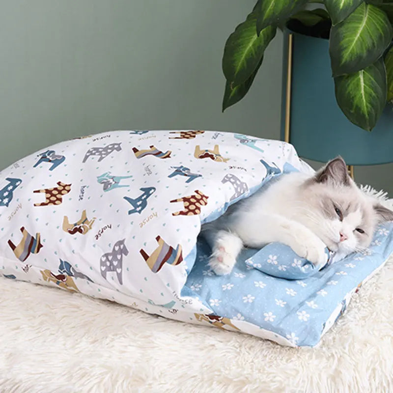 A cozy cat resting comfortably inside the Deep-Sleep Cat Sleeping Bag - Self-Warming Burrower Bed & Thermal Hideaway, featuring a soft blue interior and playful animal print exterior.