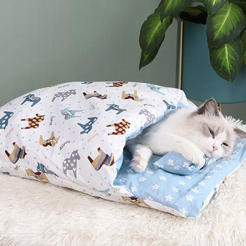A cozy cat resting comfortably inside the Deep-Sleep Cat Sleeping Bag - Self-Warming Burrower Bed & Thermal Hideaway, featuring a soft blue interior and playful animal print exterior.