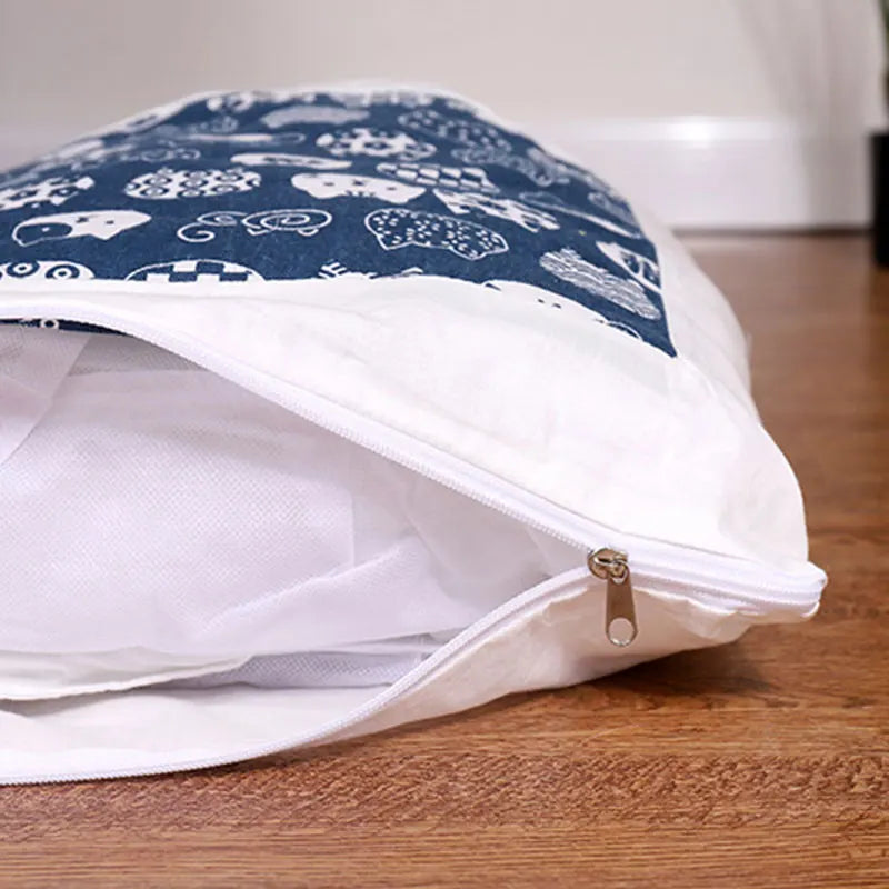Close-up of a partially unzipped Deep-Sleep Cat Sleeping Bag - Self-Warming Burrower Bed & Thermal Hideaway featuring a soft inner lining and a blue patterned outer fabric on a wooden floor.