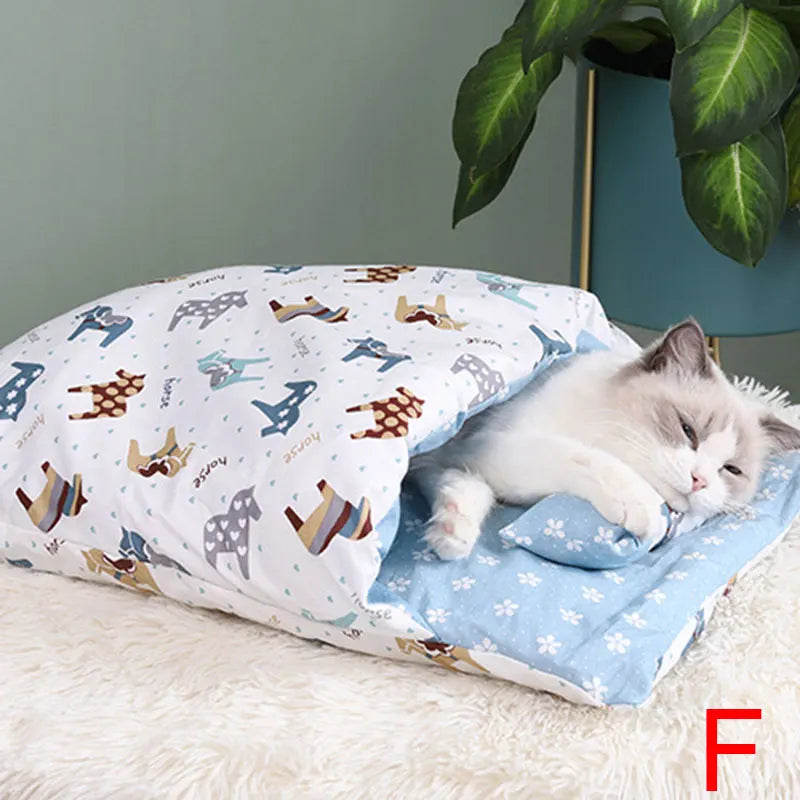 A relaxed cat resting inside the Deep-Sleep Cat Sleeping Bag - Self-Warming Burrower Bed & Thermal Hideaway, featuring a soft blue floral interior and playful dog pattern exterior.
